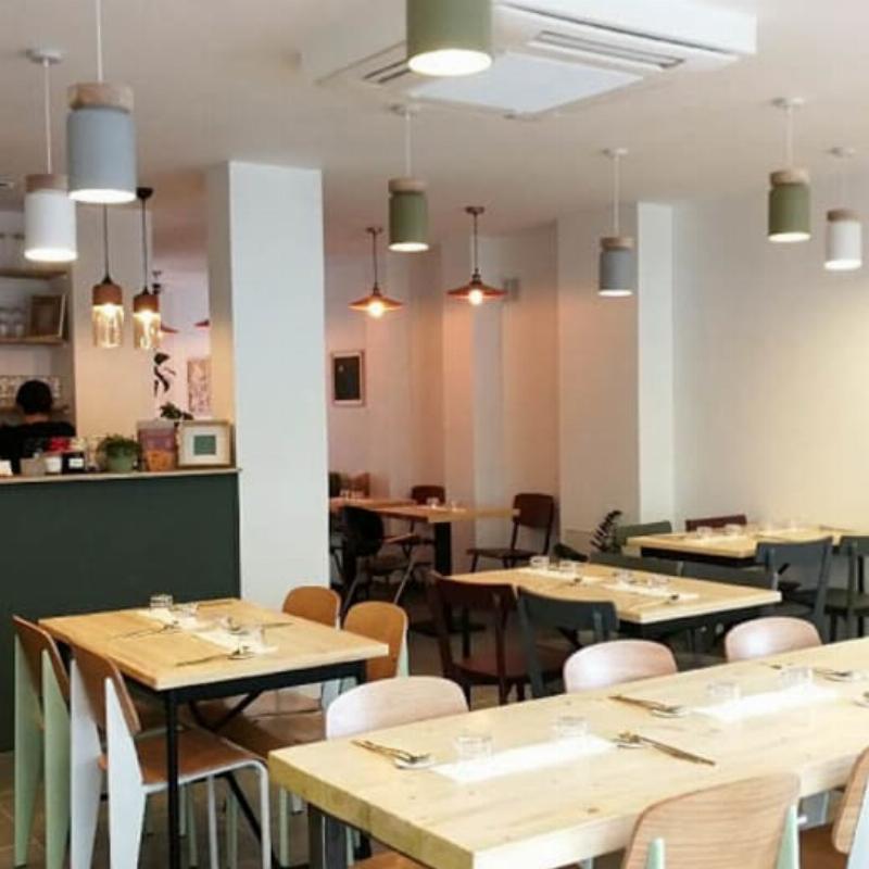 Intérieur élégant et lumineux d'un restaurant parisien traditionnel près de Notre Dame, murs en pierre et arches