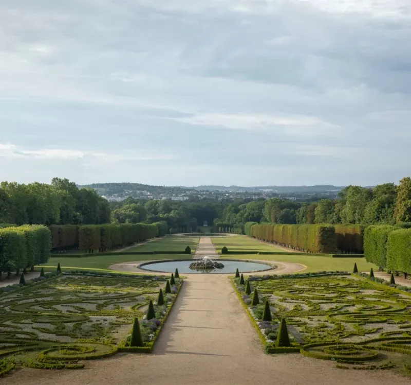 Vue aérienne des jardins de Versailles, montrant la symétrie et l'harmonie des parterres et des allées