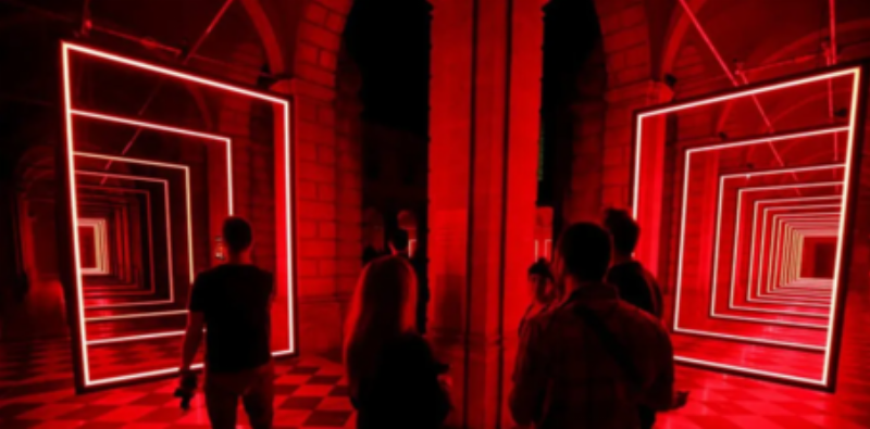 Une exposition dans une galerie d'art urbain avec un éclairage créatif et des visiteurs