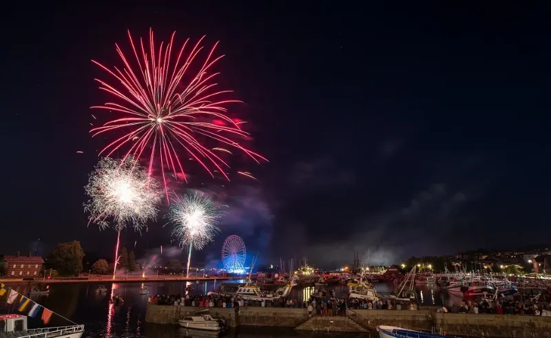 Une scène joyeuse d'une fête de village traditionnelle en France, avec habitants et animations locales