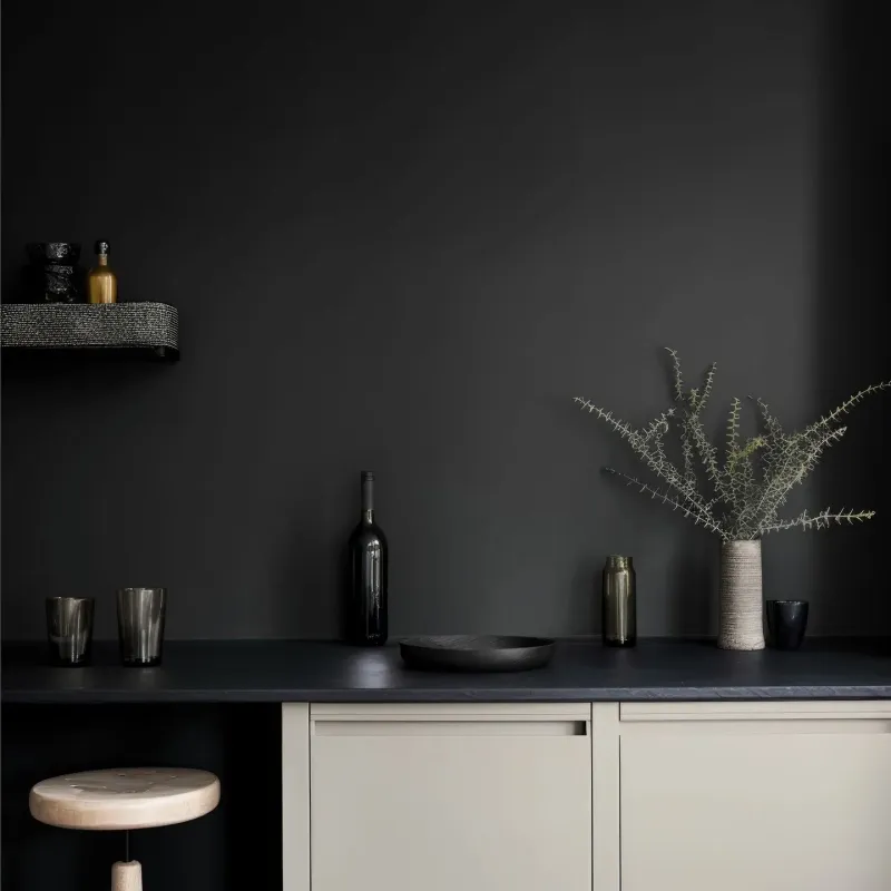 Galerie d'art moderne avec un mur d'accent vert-gris, des œuvres d'art contemporaines et une lumière d'ambiance raffinée.