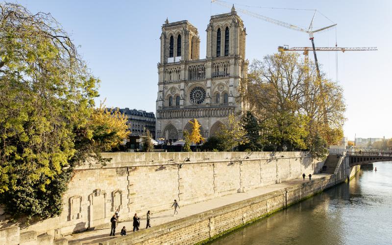Un ouvrier spécialisé travaillant sur un détail architectural de la porte de Notre-Dame