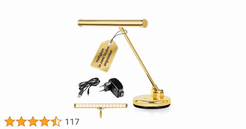 Partition ancienne de musique classique posée sur un piano, éclairée par une lumière douce