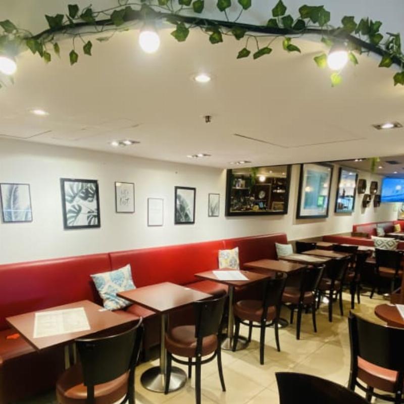 Une cage d'escalier française lumineuse avec des murs clairs et une rampe en fer forgé élégante