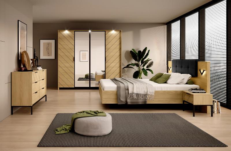 Une pièce moderne avec un grand miroir réfléchissant un mur de couleur claire, accentuant l'effet d'agrandissement de l'espace