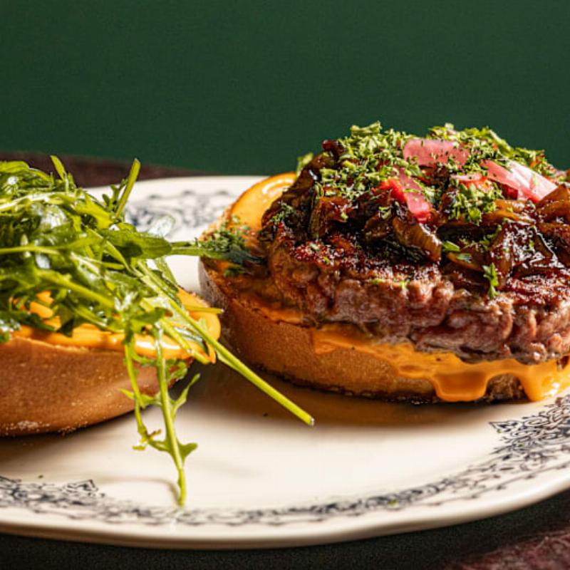 Un plat gastronomique français raffiné, élégamment présenté dans une ambiance de restaurant sophistiquée près de Notre-Dame.
