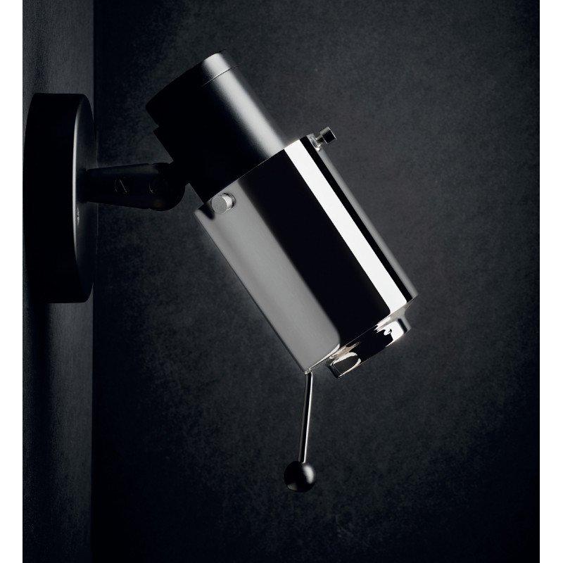 Une sculpture de chat en bronze poli capturant les reflets de la lumière, placée dans un intérieur moderne.