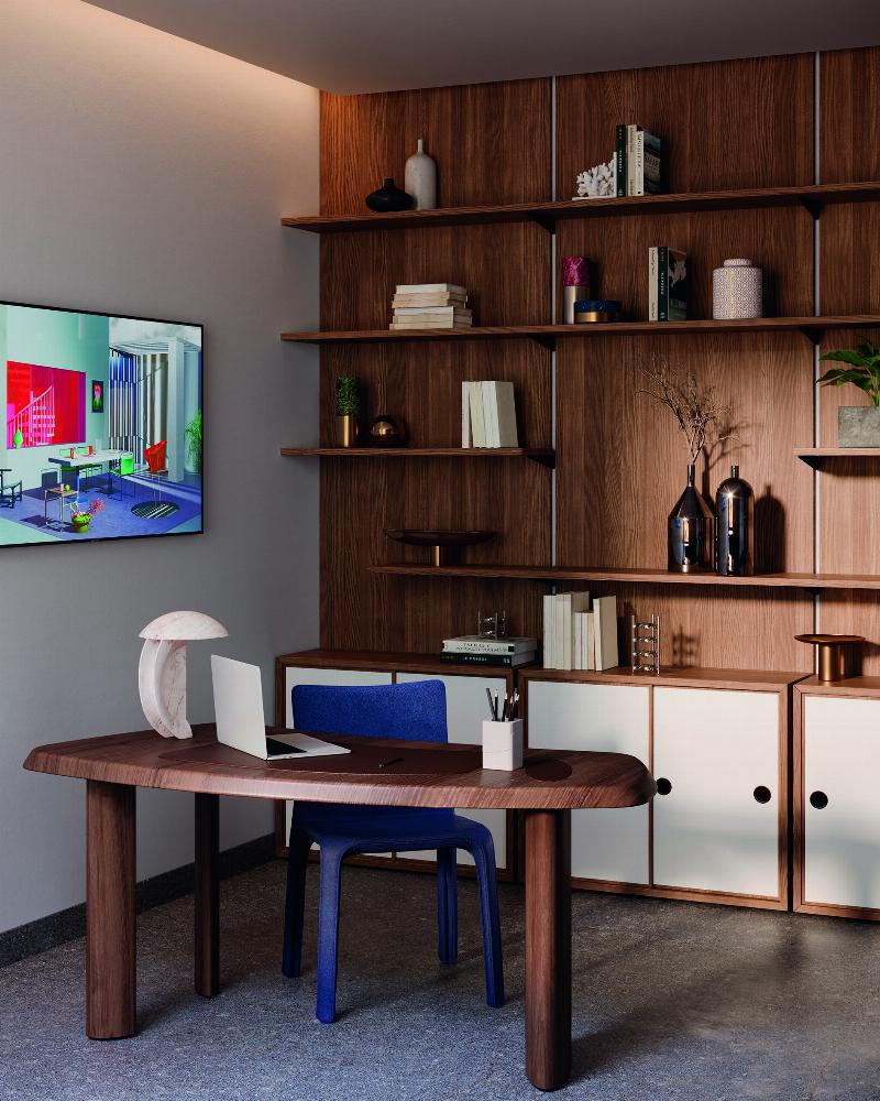 Un fauteuil Le Corbusier Cassina noir dans un intérieur moderne, avec des accents de design français et une lumière naturelle abondante.