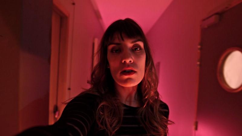 Une artiste pop française chantant sur scène, lumière tamisée, ambiance moderne